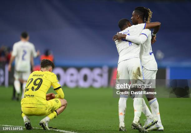 Kai Havertz of Chelsea looks dejected following their side's defeat as David Alaba celebrates with teammate Eduardo Camavinga of Real Madrid after...