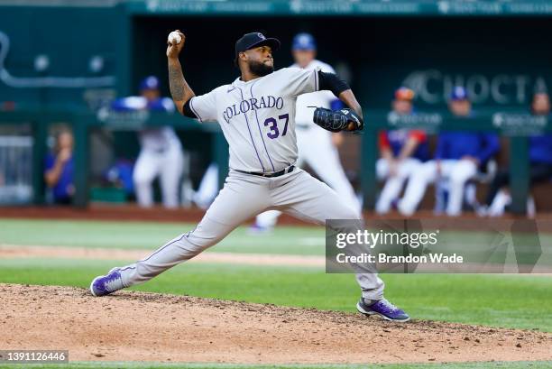 Relief pitcher Alex Colome of the Colorado Rockies throws in the eighth inning of a baseball game against the Texas Rangers during Opening Day at...