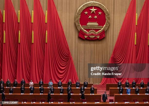 Chinese President Xi Jinping, bottom right, is applauded as he arrives at a ceremony to honour contributions to the Beijing 2022 Winter Olympics and...