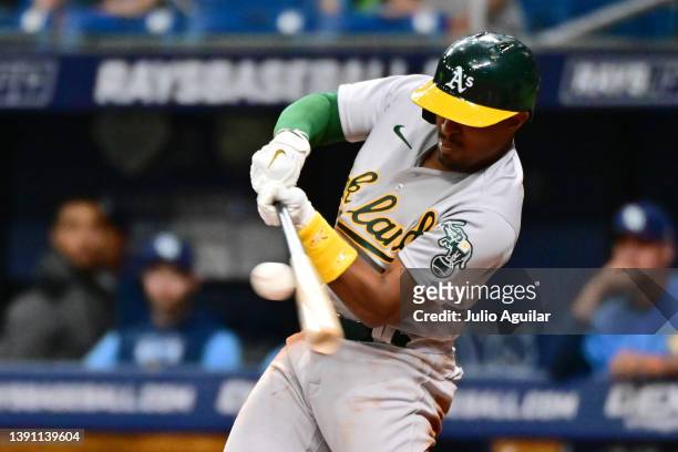 Tony Kemp of the Oakland Athletics hits a single in the second inning against the Tampa Bay Rays at Tropicana Field on April 12, 2022 in St...