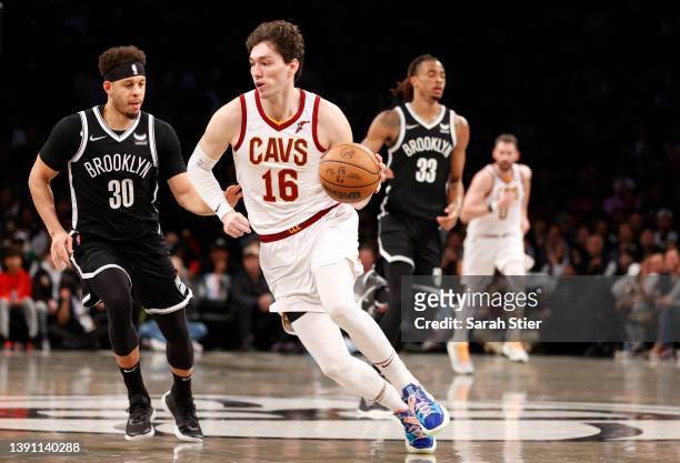 Cedi Osman of the Cleveland Cavaliers dribbles as Seth Curry of the Brooklyn Nets defends during the second half of the Eastern Conference 2022...