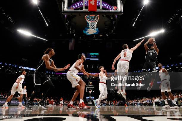 Kyrie Irving of the Brooklyn Nets goes to the basket as Kevin Love of the Cleveland Cavaliers defends during the Eastern Conference 2022 Play-In...