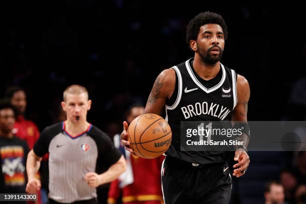 Kyrie Irving of the Brooklyn Nets dribbles during the first half of the Eastern Conference 2022 Play-In Tournament against the Cleveland Cavaliers at...