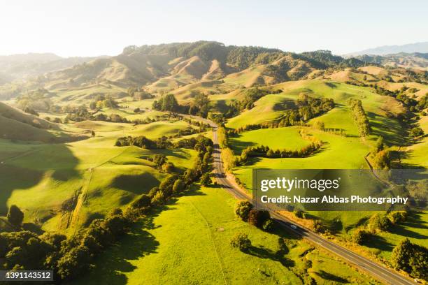 countryside landscape with road, aerial view. - new zealand farm stock pictures, royalty-free photos & images