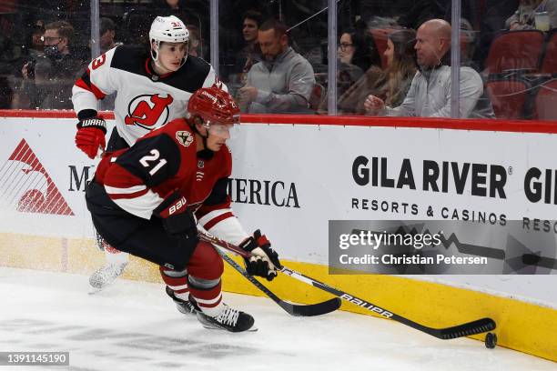 Loui Eriksson of the Arizona Coyotes controls the puck ahead of Ryan Graves of the New Jersey Devils during the first period of the NHL game at Gila...