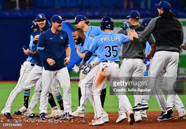 Manuel Margot of the Tampa Bay Rays celebrates with teammates after hitting an RBI walk-off single in the 10th inning for a 9-8 win over the Oakland...