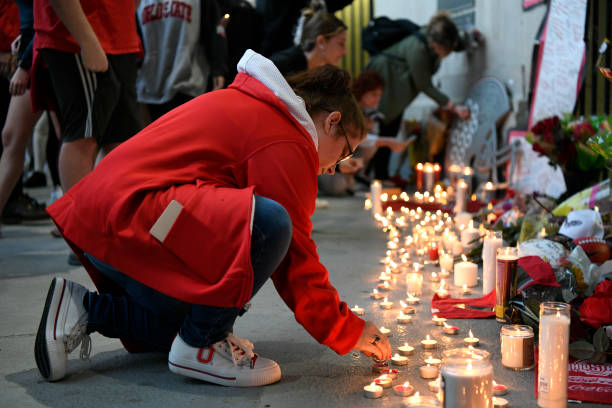 Fan lights a candle during a candlelight vigil in memory of Dwayne Haskins at Ohio Stadium on April 12, 2022 in Columbus, Ohio. Pittsburgh Steelers...