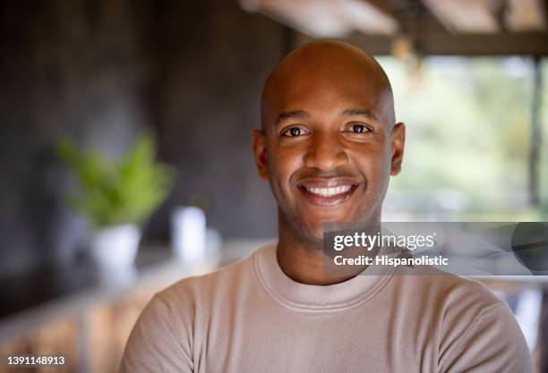 happy black man smiling at home - modern manlighet bildbanksfoton och bilder