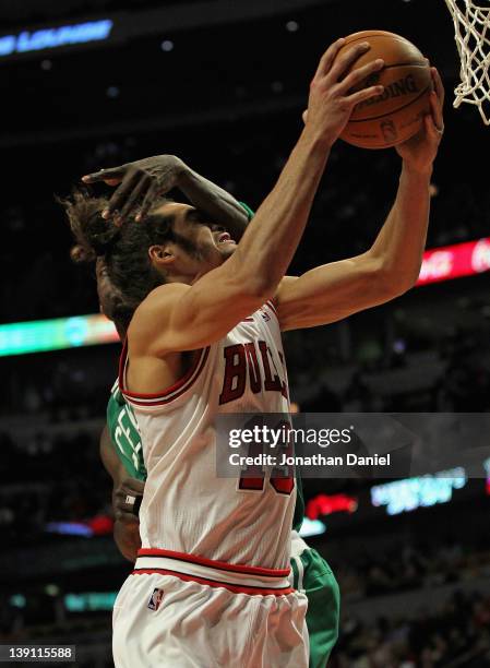 Joakim Noah of the Chicago Bulls is fouled by Kevin Garnett of the Boston Celtics at the United Center on February 16, 2012 in Chicago, Illinois. The...