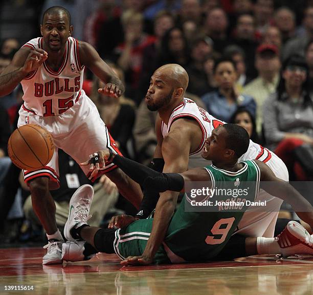 John Lucas III and Taj Gibson of the Chicago Bulls battle for a loose ball with Rajon Rondo of the Boston Celtics at the United Center on February...