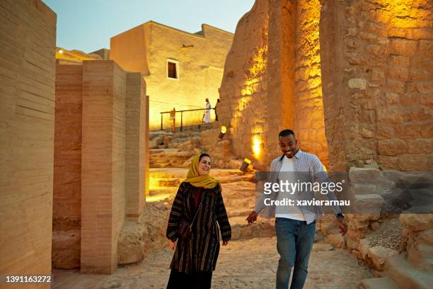 smiling tourists walking through open air museum near riyadh - abba museum stock pictures, royalty-free photos & images
