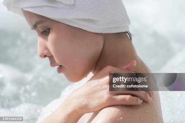 portrait asian woman in hot tub tub - woman bath tub wet hair stock pictures, royalty-free photos & images