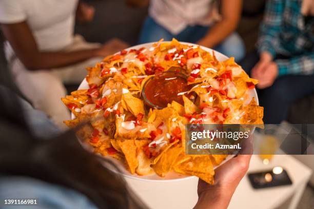 tasty looking mexican nachos pov - cheese sauce stock pictures, royalty-free photos & images