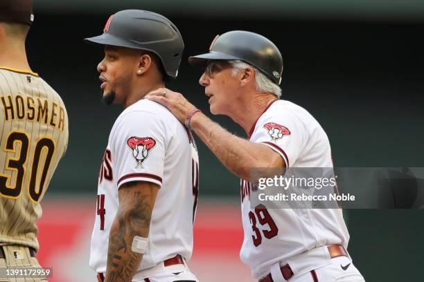 First base coach Dave McKay of the Arizona Diamondbacks speaks with outfielder Ketel Marte of the Arizona Diamondbacks during their MLB game against...