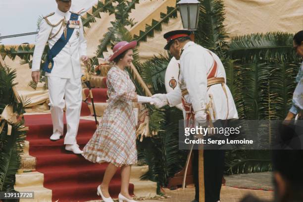 Queen Elizabeth II and Prince Philip are greeted by King Taufa'ahau Tupou IV upon their arrival in Tonga, February 1977.