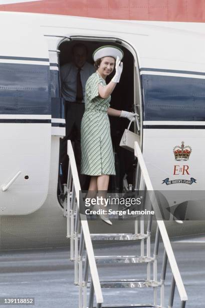 Queen Elizabeth II leaves Fiji during her royal tour, February 1977. Prince Philip is just visible behind her.