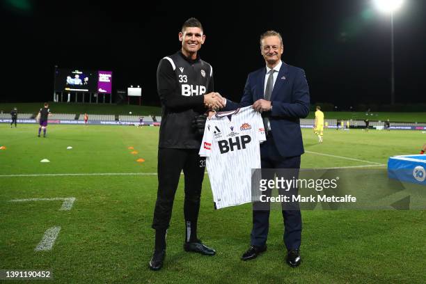 Perth Glory CEO Tony Pignata presents a jersey to Liam Reddy of the Glory on his 400th national league appearance during the A-League Mens match...
