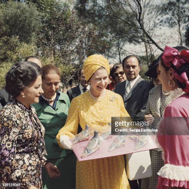 Queen Elizabeth II receives some local crafts during her state visit to Mexico, 1975.