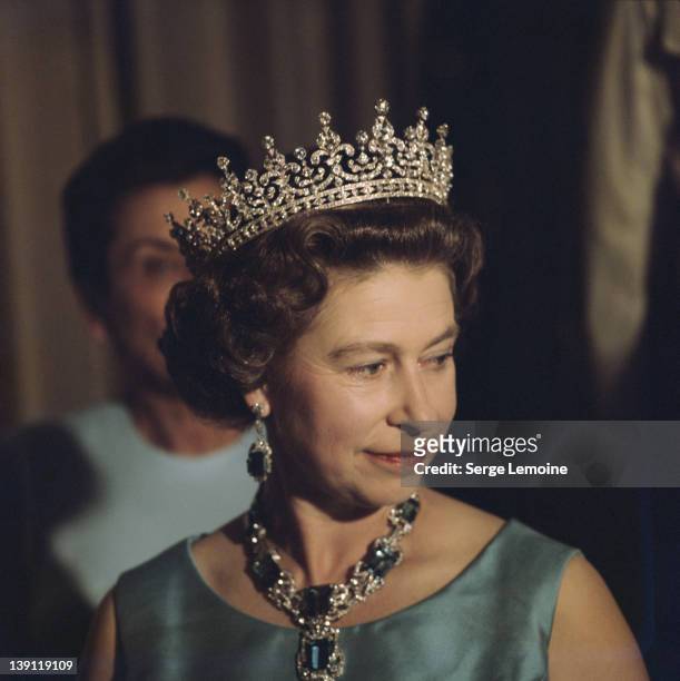 Queen Elizabeth II in a crown and jewelled necklace, 1975.
