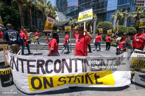 Striking hotel workers walk the picket line outside the Intercontinental Hotel in Los Angeles, California, on July 2, 2023. Thousands of hotel...