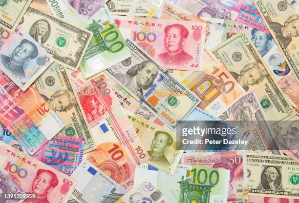 In this photo illustration a collection of global paper currency, on December 16,2021 in London, England.