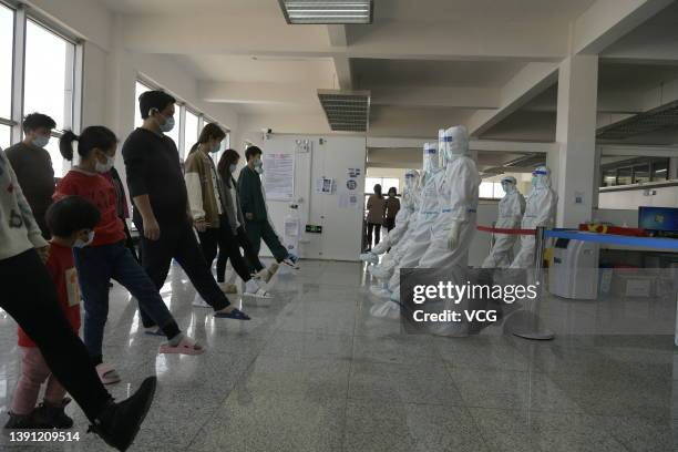 Covid-19 patients and medical workers do exercise at a makeshift hospital on March 12, 2022 in Jilin, Jilin Province of China.