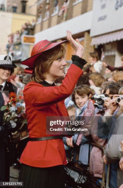 British Royals Diana, Princess of Wales , wearing a red-and-black Donald Campbell suit and a John Boyd hat, greets well wishers during a visit to...