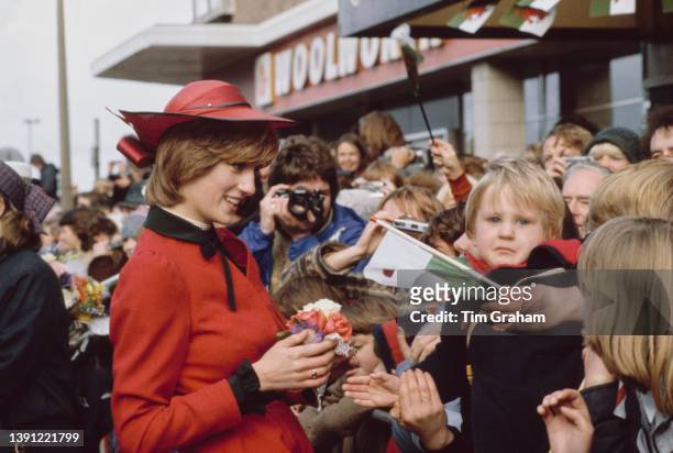 British Royals Diana, Princess of Wales , wearing a red-and-black Donald Campbell suit and a John Boyd hat, greets well wishers during a visit to...