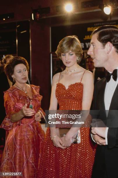 British Royal Princess Margaret, Countess of Snowdon , Lady Diana Spencer , wearing a red-and-gold spangled chiffon Bellville Sassoon gown, and...