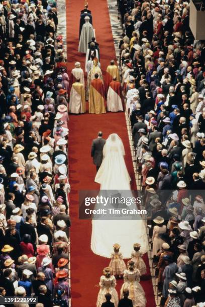 British noblewoman Lady Diana Spencer, wearing a wedding dress designed by David and Elizabeth Emanuel, with her father, John Spencer, 8th Earl...