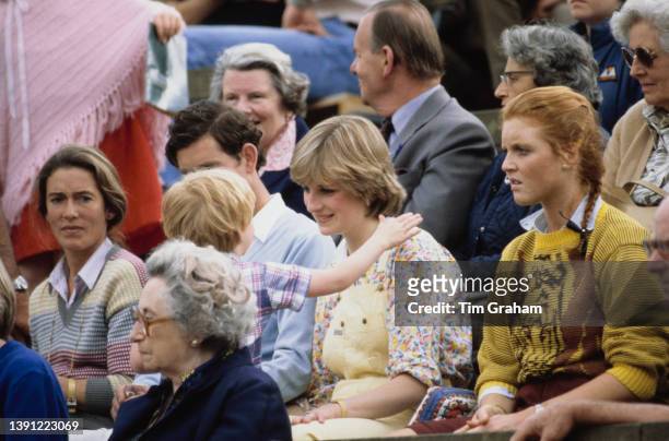 Susan Barrantes , mother of Sarah Ferguson, Charles , Prince of Wales, British noblewoman Lady Diana Spencer, wearing yellow dungarees with a...