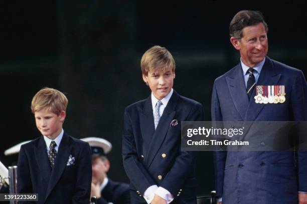 British Royals Prince Harry, Prince William, and Charles, Prince of Wales, attend the parade commemorating VJ Day, outside Buckingham Palace in...