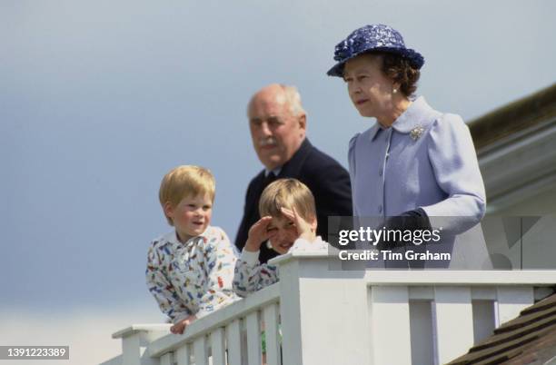 British Royals Prince Harry, Prince William, and Queen Elizabeth II in the Royal Box at the Guards Polo Club at Smiths Lawn, in Windsor Great Park,...