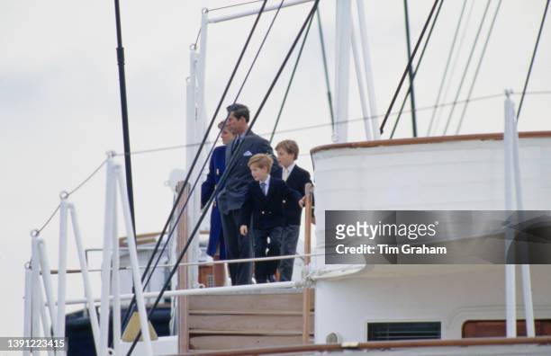 British Royals Diana, Princess of Wales , Charles, Prince of Wales, and their sons, Prince Harry and Prince William, on the deck of the Royal Yacht...