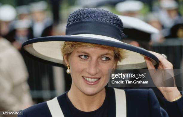 British Royal Diana, Princess of Wales , wearing a blue-and-white Catherine Walker suit and matching hat, attends the service marking the 50th...