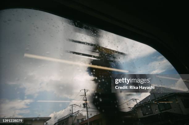 passing scenery seen from a train window - blue monday stock-fotos und bilder