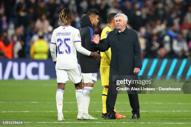 Carlo Ancelotti the manager of Real Madrid congratulates Eduardo Camavinga after the UEFA Champions League Quarter Final Leg Two match between Real...