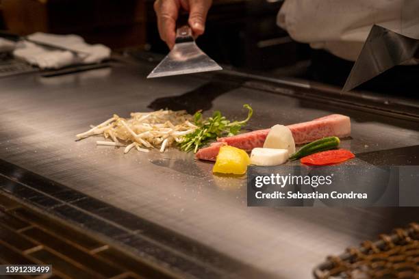 travel world. chef cooking wagyu beef in japanese restaurant. - teppanyaki stock pictures, royalty-free photos & images