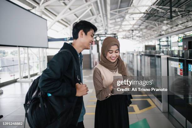 young hijab girl and young man, bestie, using smart phone - インドネシア人 ストックフォトと画像