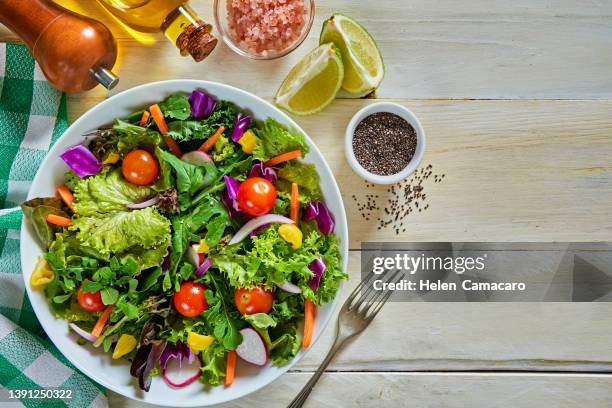 top view of fresh and healthy salad in a bowl on wooden table. - chia seed oil stock pictures, royalty-free photos & images