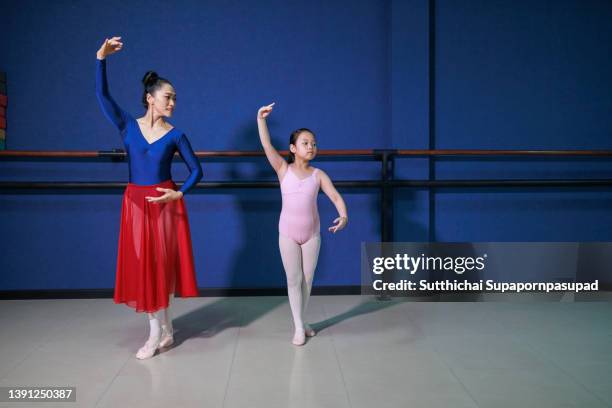 asian ballet teacher teaching a young ballerina. - dance teacher foto e immagini stock