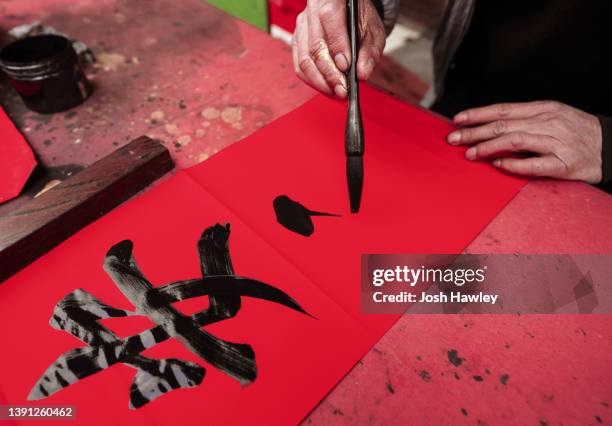 asian man writing the chinese character - ancient china stock pictures, royalty-free photos & images