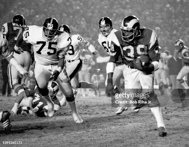 Los Angeles Rams RB Rod Phillips is pursued by Pittsburgh Steelers Joe Green , Jack Ham and Steve Furness during game action of Los Angeles Rams...