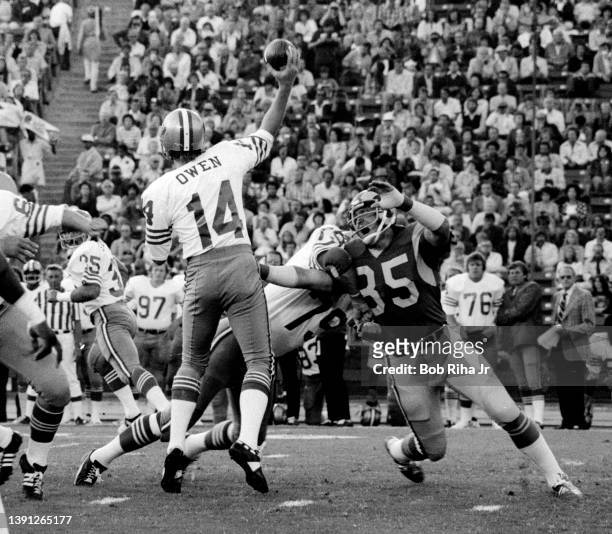 San Francisco QB Tom Owen releases a quick pass after pressure from Rams DE Jack Youngblood during game of Los Angeles Rams against San Francisco...