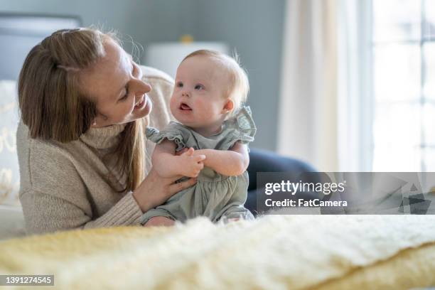 spending time with mommy - down syndrome baby stockfoto's en -beelden