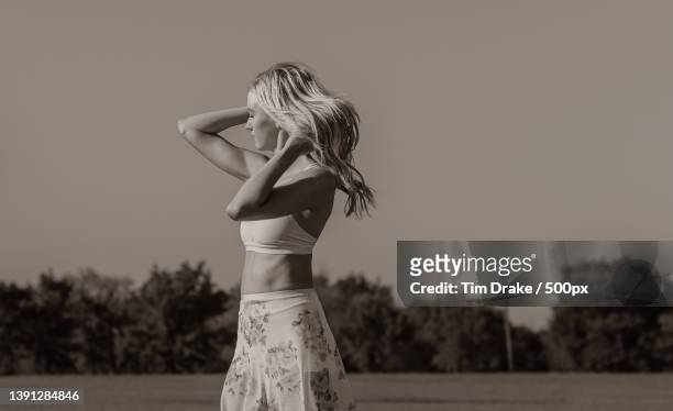 country dance,side view of young woman standing against sky - drake one dance stock-fotos und bilder