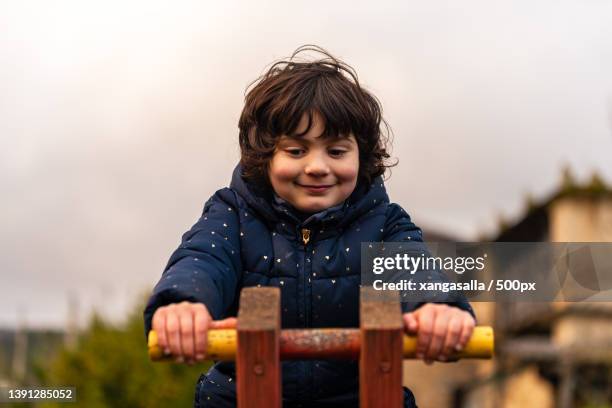 little kid playing at the park at evenig - playground balance beam stock pictures, royalty-free photos & images