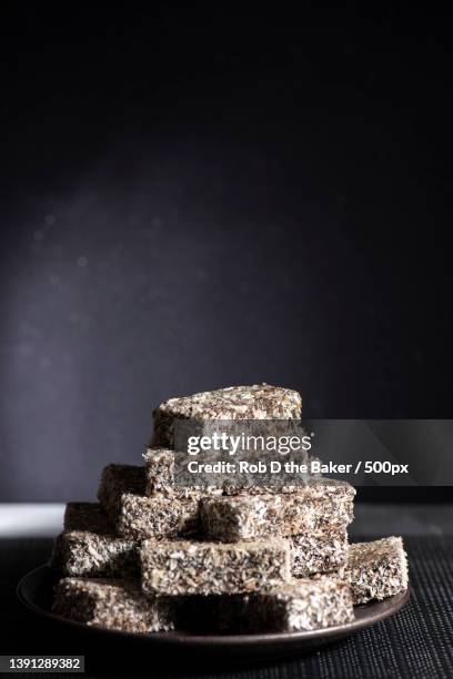 side view view of food lamington fingers flat lay concept with copy space on dark table - lamington cake stock pictures, royalty-free photos & images