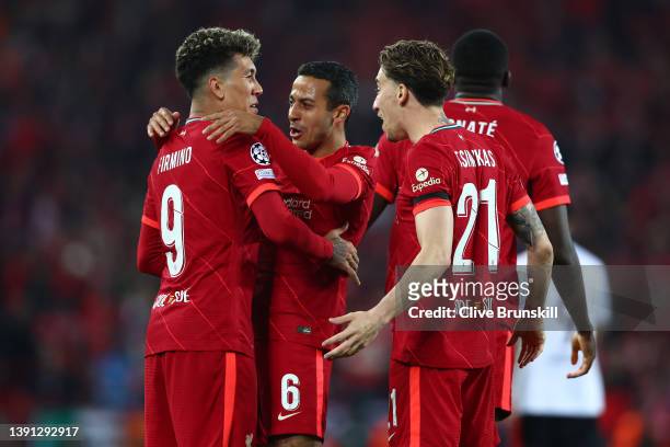 Roberto Firmino of Liverpool celebrates with Thiago Alcantara and Kostas Tsimikas after scoring their team's third goal during the UEFA Champions...