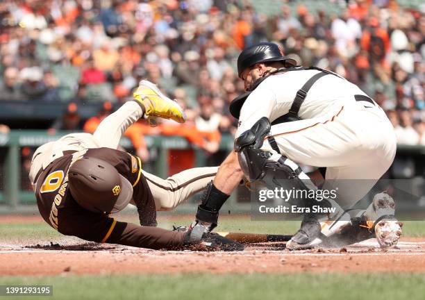 Jake Cronenworth of the San Diego Padres is tagged out by Curt Casali of the San Francisco Giants in the first inning at Oracle Park on April 13,...